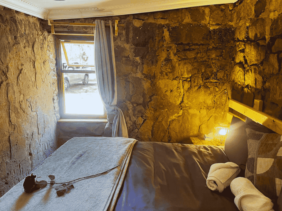 View of bed in Fred's Stone Cottage